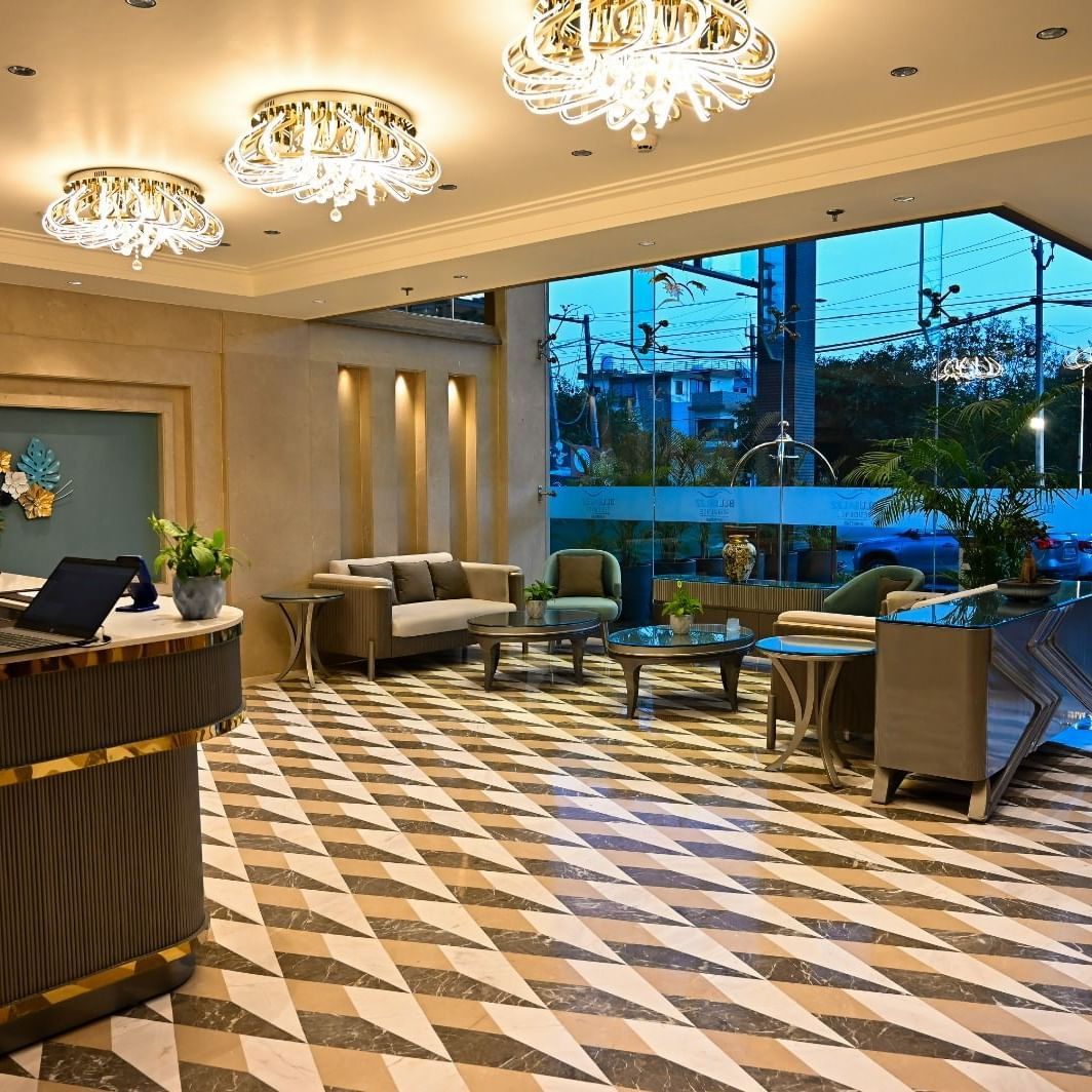 A spacious lobby featuring comfortable seating arrangements and a reception desk at 